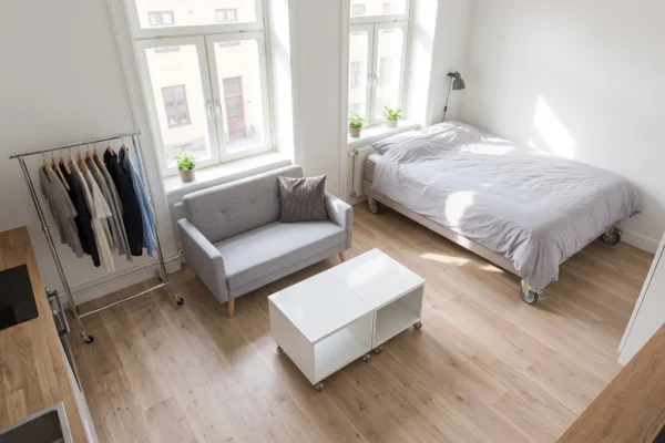Studio bedroom layout with bed, storage, and living area